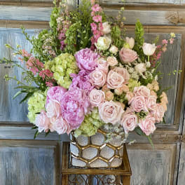 Pink and green floral arrangement in a glittery gold vase