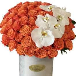 Orange rose arrangement with white orchids in a silver box