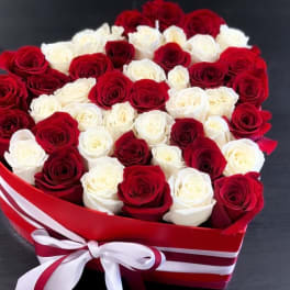 Heart-shaped box filled with red and white roses