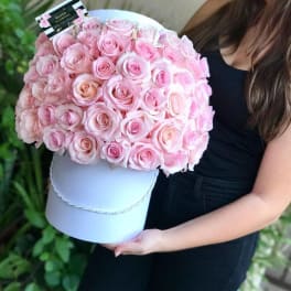 Large bouquet of pink roses in a white hat box