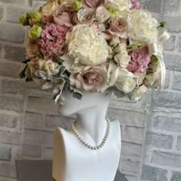 Pastel rose bouquet arranged on a white mannequin bust