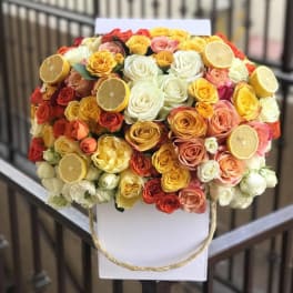 Bouquet of multicolored roses with lemon slices on a white backing