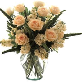 Peach rose bouquet in a clear glass vase
