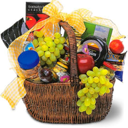 Gift basket with snacks, fruit, and a yellow checkered bow