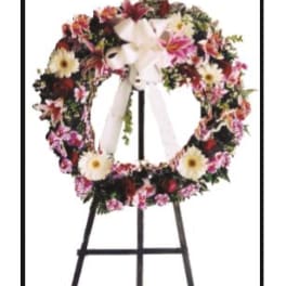 Floral wreath on a black easel with a white ribbon bow
