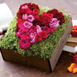 Heart-shaped rose arrangement in a wooden box