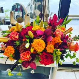 Bright mixed bouquet with roses, lilies, and orange mums