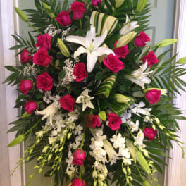 Standing spray of pink roses and white lilies with orchids
