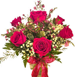 Bouquet of hot pink roses with baby's breath in a vase
