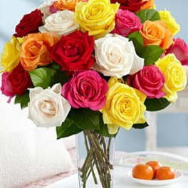 Bouquet of multicolored roses in a clear glass vase