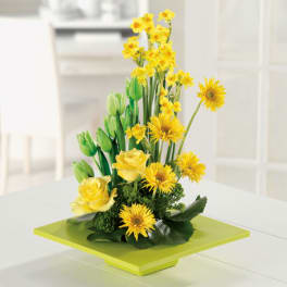 Yellow flowers and roses arranged on a lime-green pedestal