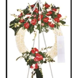 Standing funeral spray with red and white flowers on an easel