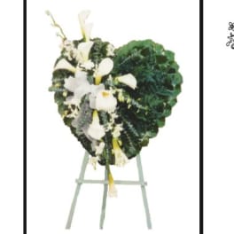 Heart-shaped floral wreath with white calla lilies on an easel