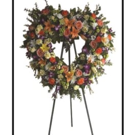 Large floral wreath on a standing easel with mixed blooms