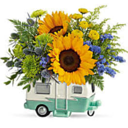 Sunflower bouquet in a small camper-shaped vase