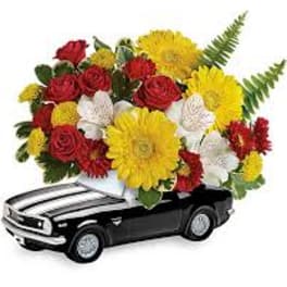Flower arrangement in a black car-shaped container