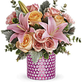 Pink lilies and roses in a pink jeweled vase