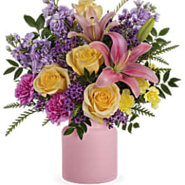 Pink lilies and yellow roses in a pink vase