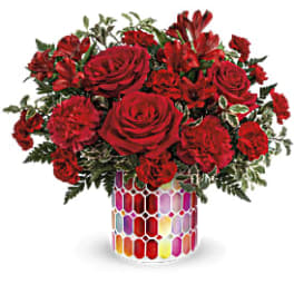 Red roses and carnations in a colorful mosaic vase