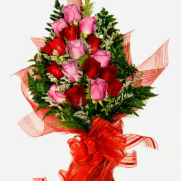 Bouquet of red and pink roses with red ribbon wrap