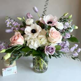 Bouquet of pale pink and white flowers in a glass vase