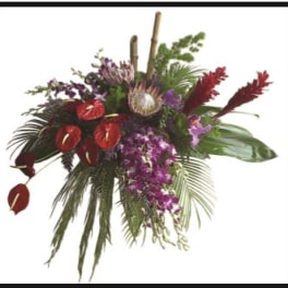 Tropical floral arrangement with red anthuriums and purple orchids