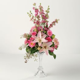 Pink and white mixed flower arrangement in a clear glass vase