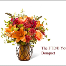 Orange and pink mixed bouquet in a decorative vase