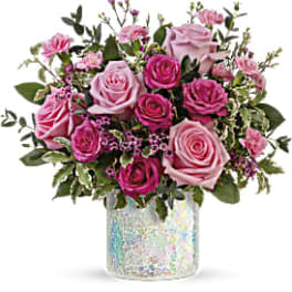 Pink and magenta roses in a clear vase