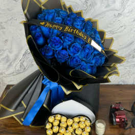 Blue rose bouquet with a birthday ribbon and heart-shaped chocolate box