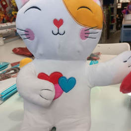 Plush cat toy with embroidered hearts and a smiling face