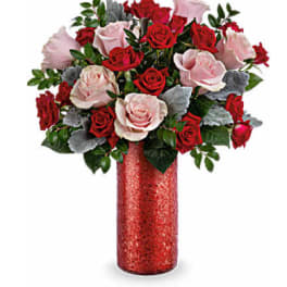 Bouquet of red and pale pink roses in a red vase