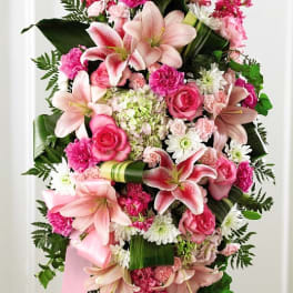 Pink and white floral standing spray with lilies and roses on an easel