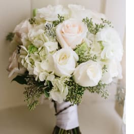 White rose bouquet with pale hydrangeas and greenery