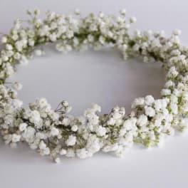 White baby's breath flower crown on a plain background