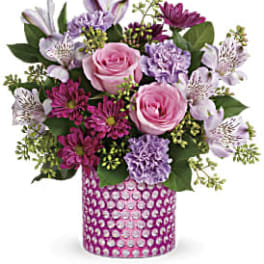 Pink and lavender mixed bouquet in a pink jeweled vase