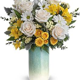 Bouquet of white roses, yellow flowers, and daisies in a teal vase