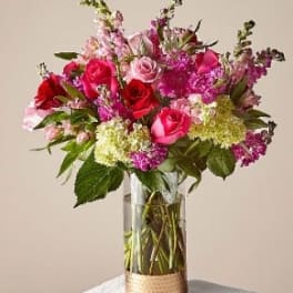 Bouquet of pink and red roses in a clear glass vase