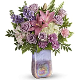 Pink lilies and lavender roses in a tall iridescent vase
