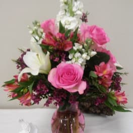 Pink and white mixed bouquet in a pink glass vase