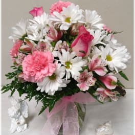 Pink and white bouquet with daisies, roses, and carnations in a glass vase