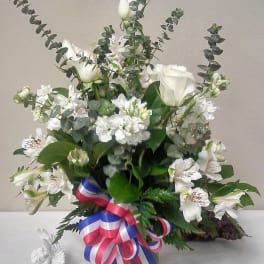 White floral arrangement with roses and alstroemeria in a glass vase