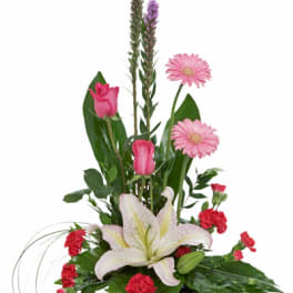 Tall pink and white arrangement with lilies, roses, gerbera daisies and carnations in a low black container