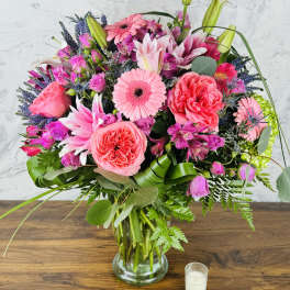 Pink and purple mixed bouquet in a glass vase