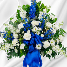 White and blue floral spray with a satin ribbon bow