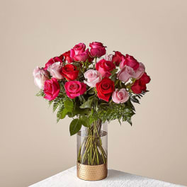 Bouquet of pink and red roses in a clear glass vase