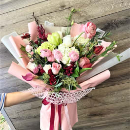 Pink and white mixed bouquet wrapped in pastel paper