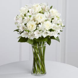 White roses and alstroemeria in a clear glass vase