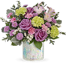 Pink and lavender bouquet in a iridescent glass vase