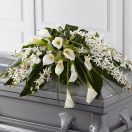 White floral casket spray with calla lilies and orchids